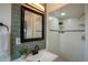 Stylish bathroom with green tile backsplash, modern fixtures, and a shower at 9390 W Alabama Dr, Lakewood, CO 80232