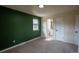 Cozy bedroom featuring a neutral carpet, green accent wall, and adjacent bathroom at 9390 W Alabama Dr, Lakewood, CO 80232