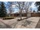 Lovely brick home with a well-maintained lawn, mature trees, and wide driveway at 9390 W Alabama Dr, Lakewood, CO 80232