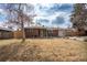 Inviting brick home with a manicured lawn, mature trees, and a welcoming front entrance at 9390 W Alabama Dr, Lakewood, CO 80232