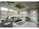 Bright living room with large windows, skylight, hardwood floors, and modern furniture at 9390 W Alabama Dr, Lakewood, CO 80232