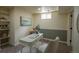 Finished basement office with neutral colors, white desk and chair, a window, and shelving at 9390 W Alabama Dr, Lakewood, CO 80232