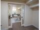 Cozy finished basement office space featuring sliding doors, white desk, chair and neutral colors at 9390 W Alabama Dr, Lakewood, CO 80232