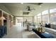 Open concept living and dining area bathed in sunlight with vaulted ceilings and modern decor at 9390 W Alabama Dr, Lakewood, CO 80232