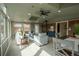 Bright sun room with lots of windows, brick accent wall, a fireplace, and modern furnishings at 9390 W Alabama Dr, Lakewood, CO 80232