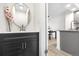 Stylish half-bath with dark vanity, round mirror, and a view to dining area at 1055 Milo Cir # A, Lafayette, CO 80026