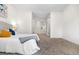 Bright bedroom showing a cozy bed and neutral tones in the bedroom's carpet and open hallway at 1055 Milo Cir # A, Lafayette, CO 80026