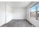 Bright bedroom featuring neutral gray carpet and a large window offering ample natural light at 1055 Milo Cir # A, Lafayette, CO 80026