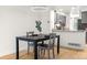 Dining area with stylish table, bright light and a view of the modern kitchen at 1055 Milo Cir # A, Lafayette, CO 80026