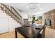 Dining area with decorative lighting fixture, stone fireplace and staircase at 1055 Milo Cir # A, Lafayette, CO 80026