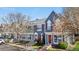 Charming townhouse featuring a blue exterior, red shutters, and a well-maintained yard at 1055 Milo Cir # A, Lafayette, CO 80026