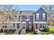 Charming townhouse featuring a blue exterior, red shutters, and a well-maintained front yard at 1055 Milo Cir # A, Lafayette, CO 80026