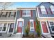 Charming townhouse with an attractive exterior, red shutters, and a well-maintained front yard at 1055 Milo Cir # A, Lafayette, CO 80026