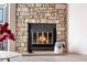 Inviting fireplace features a stone surround and a glass-fronted firebox, creating a cozy focal point at 1055 Milo Cir # A, Lafayette, CO 80026