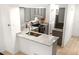 Kitchen featuring gray cabinets, stainless appliances, breakfast bar, and wood-look flooring at 1055 Milo Cir # A, Lafayette, CO 80026