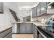 Updated kitchen with gray cabinets, stainless steel appliances, and granite countertops at 1055 Milo Cir # A, Lafayette, CO 80026