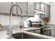 Modern kitchen featuring gray cabinets, stainless steel appliances, and granite countertops at 1055 Milo Cir # A, Lafayette, CO 80026