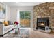 Cozy living room with a stone fireplace, with sliding glass doors leading to the outdoors at 1055 Milo Cir # A, Lafayette, CO 80026