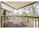 Balcony with wooden floors and railings, offering a view of blooming trees and neighborhood street at 381 S Ames St # E305, Lakewood, CO 80226