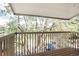 Relaxing balcony view of flowering trees with wooden floors and light-colored railings at 381 S Ames St # E305, Lakewood, CO 80226