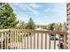 Balcony with a view of well-maintained parking and mature trees under a blue sky at 381 S Ames St # E305, Lakewood, CO 80226