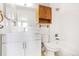 Bright bathroom featuring a white vanity, wooden cabinet, and shower-over-tub combination at 381 S Ames St # E305, Lakewood, CO 80226