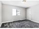 Neutral-toned bedroom with gray carpet, bright window, white trim, and large closet at 381 S Ames St # E305, Lakewood, CO 80226