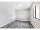 Cozy bedroom with soft gray carpet, neutral walls, bright window, and ample natural light at 381 S Ames St # E305, Lakewood, CO 80226