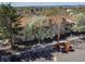 Exterior aerial view of a multi-story building with balconies, landscaping, and a parking lot at 381 S Ames St # E305, Lakewood, CO 80226
