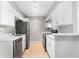 Bright kitchen featuring stainless steel appliances, white cabinets, and white countertops at 381 S Ames St # E305, Lakewood, CO 80226