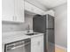 Bright kitchen featuring stainless steel appliances, white cabinets, and white countertops at 381 S Ames St # E305, Lakewood, CO 80226