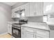 Bright kitchen featuring modern stainless steel appliances, white cabinets, and white countertops at 381 S Ames St # E305, Lakewood, CO 80226
