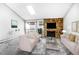 Living room with stone fireplace, modern furnishings, and sliding doors to the balcony at 381 S Ames St # E305, Lakewood, CO 80226
