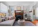 Living room with fireplace, hardwood floors, and large windows at 1018 E 4Th Ave, Denver, CO 80218