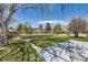 Beautiful backyard featuring a well-maintained lawn and a wooden deck, perfect for relaxing outdoors at 5975 S Milwaukee Way, Centennial, CO 80121