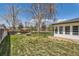 Lush backyard with green lawn, wooden fence, mature trees, and a gazebo at 5975 S Milwaukee Way, Centennial, CO 80121