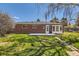 Expansive backyard with brick accents and sunroom, perfect for outdoor gatherings and enjoying nature at 5975 S Milwaukee Way, Centennial, CO 80121
