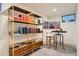 Basement living space with stylish gold shelving and a cozy table and chair at 5975 S Milwaukee Way, Centennial, CO 80121