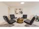 Basement featuring a seating area with modern chairs, a round table, and a painting at 5975 S Milwaukee Way, Centennial, CO 80121