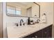Well-lit bathroom featuring a double sink vanity with a modern faucet, and decorative fixtures at 5975 S Milwaukee Way, Centennial, CO 80121