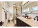 Modern bathroom with a glass-enclosed shower, double sink vanity, and stylish fixtures at 5975 S Milwaukee Way, Centennial, CO 80121
