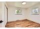 Bright, empty bedroom features a large closet, hardwood floors and two windows at 5975 S Milwaukee Way, Centennial, CO 80121