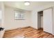 Bright bedroom featuring hardwood floors, a closet, and a window with a view at 5975 S Milwaukee Way, Centennial, CO 80121