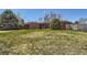 Beautifully landscaped front yard leading to a classic brick home with a two-car garage at 5975 S Milwaukee Way, Centennial, CO 80121