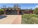 Charming brick home with attached garage and well-manicured lawn on a sunny day at 5975 S Milwaukee Way, Centennial, CO 80121
