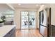 Bright kitchen featuring stainless steel appliances, light wood floors, and a view to the dining area at 5975 S Milwaukee Way, Centennial, CO 80121