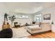 Bright living room with hardwood floors, a large sectional sofa, and abundant natural light at 5975 S Milwaukee Way, Centennial, CO 80121