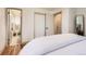 Bedroom featuring hardwood floors, closet, access to the bathroom, and neutral decor at 5975 S Milwaukee Way, Centennial, CO 80121