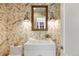 Powder room featuring floral wallpaper, vessel sink and sconces at 38 Sedgwick Dr, Cherry Hills Village, CO 80113