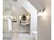 Bright bathroom featuring a glass-enclosed shower and sleek fixtures under a sloped ceiling at 38 Sedgwick Dr, Cherry Hills Village, CO 80113